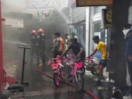 Firefighters attempt to douse a blaze in a godown at the Jhandewalan cycle market, in New Delhi, on Friday. Firefighters attempt to douse a blaze in a godown at the Jhandewalan cycle market, in New Delhi, on Friday.