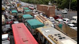 Motorists stuck on the Sion-Panvel Highway for hours after a dumper went off the road on the Vashi bridge on Friday morning.  (BACHCHAN KUMAR/HT PHOTO)