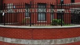 Signage for Massachusetts General Hospital, where a patient is being treated for monkeypox, is pictured on a fence at the hospital in Boston, Massachusetts, on May 19, 2022.&nbsp;