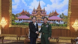 In this photo provided by the Myanmar Military True News Information Team, Senior Gen. Min Aung Hlaing, right, head of the military council, shakes hand with Yawd Serk, chairman of Shan State Army, during their meeting Friday, May 20, 2022, in Naypyitaw, Myanmar. (Military True News Information Team via AP)