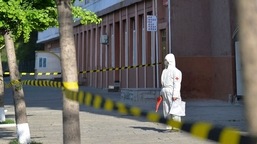 In this photo provided by the North Korean government, a worker in protective gear stands on an empty sidewalk in Pyongyang, on May 17, 2022.&nbsp;