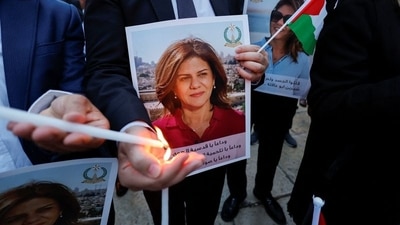 People light candles during a vigil in memory of Al Jazeera journalist Shireen Abu Akleh, who was killed during an Israeli raid, outside the Church of the Nativity in Bethlehem, in the Israeli-occupied West Bank. (REUTERS)