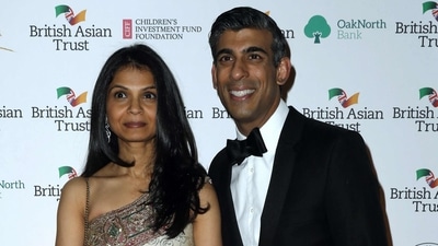 Britain's Chancellor of the Exchequer Rishi Sunak (R) poses with his wife Akshata Murty. (AFP)