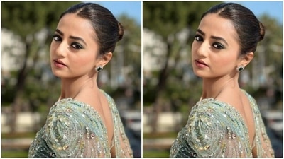 Helly Shah’s pastel blue gown came with midriff-baring details and embellishments in silver resham threads and rhinestones. The gown also featured a dramatic cape around her shoulders. (Instagram/@hellyshahofficial)
