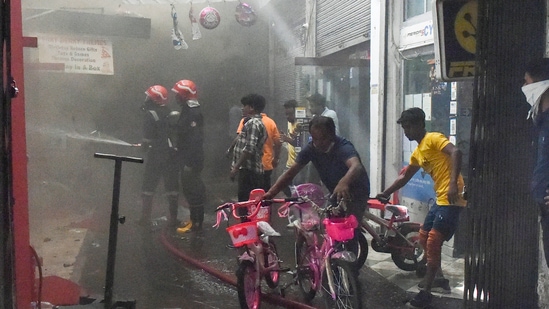 Firefighters attempt to douse a blaze in a godown at the Jhandewalan cycle market, in New Delhi, on Friday.(PTI)