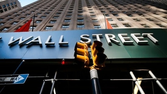A sign for a Wall Street building is shown, (AP file photo) A sign for a Wall Street building is shown, (AP file photo)