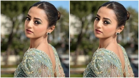 Helly Shah’s pastel blue gown came with midriff-baring details and embellishments in silver resham threads and rhinestones. The gown also featured a dramatic cape around her shoulders.(Instagram/@hellyshahofficial)