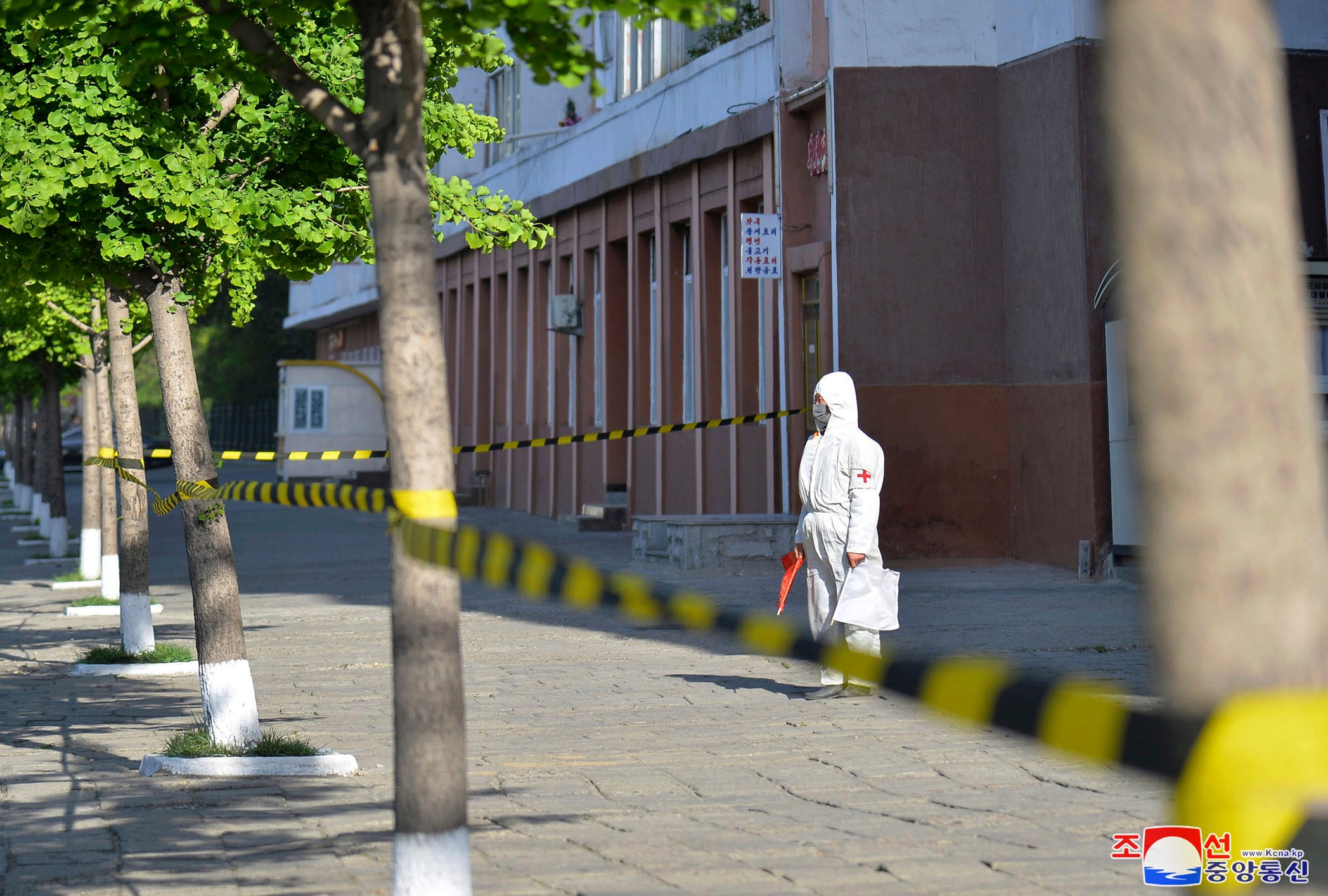 In this photo provided by the North Korean government, a worker in protective gear stands on an empty sidewalk in Pyongyang, on May 17, 2022. (Korean Central News Agency/Korea News Service via AP) In this photo provided by the North Korean government, a worker in protective gear stands on an empty sidewalk in Pyongyang, on May 17, 2022. (Korean Central News Agency/Korea News Service via AP)