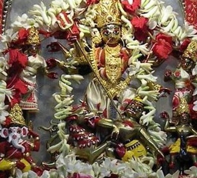 The vajra-dharan mudra is formed by every idol in the Dhakeshwari tableau, even the just-slain Asura.