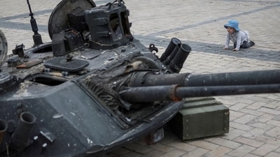 A child looks at a destroyed Russian infantry fighting vehicle during an exhibition displaying destroyed Russian military vehicles, amid Russia's invasion, in central Kyiv, Ukraine. (REUTERS)