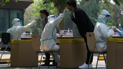 Residents get swabbed for mass Covid test in Beijing. (AP) Residents get swabbed for mass Covid test in Beijing. (AP)