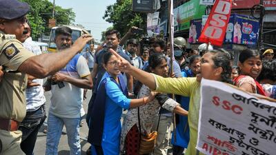West Bengal Police personnel try to reason with members of the All India Democratic Youth Organisation (AIDYO) and All India Democratic Students' Organisation (AIDSO) during their protest march towards Chief Minister Mamata Banerjee's residence over state ministers' involvement in the SSC recruitment scam in Kolkata on Friday. (PTI PHOTO.) West Bengal Police personnel try to reason with members of the All India Democratic Youth Organisation (AIDYO) and All India Democratic Students' Organisation (AIDSO) during their protest march towards Chief Minister Mamata Banerjee's residence over state ministers' involvement in the SSC recruitment scam in Kolkata on Friday. (PTI PHOTO.)