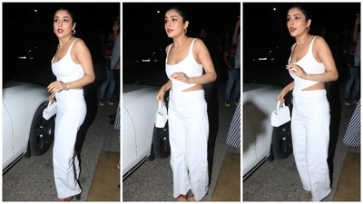 Shehnaaz chose an all-white ensemble for the occasion, and it screamed elegance mixed with trendy vibes. Her fit for the party features a sleeveless corset top with a plunging neckline and back, structured boning to hug Shehnaaz's curves, asymmetrical cropped hemline, and a fitted bodice. (HT Photo/Varinder Chawla) Shehnaaz chose an all-white ensemble for the occasion, and it screamed elegance mixed with trendy vibes. Her fit for the party features a sleeveless corset top with a plunging neckline and back, structured boning to hug Shehnaaz's curves, asymmetrical cropped hemline, and a fitted bodice. (HT Photo/Varinder Chawla)