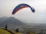 A tourist enjoys paragliding over the city in Srinagar on Sunday.  (Imran Nissar/ANI Photo)