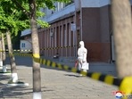 In this photo provided by the North Korean government, a worker in protective gear stands on an empty sidewalk in Pyongyang. In this photo provided by the North Korean government, a worker in protective gear stands on an empty sidewalk in Pyongyang.