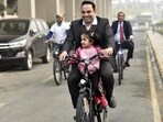 People ride e-cycles in Delhi NCR.