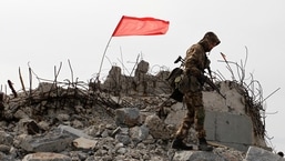 FILE PHOTO: A serviceman of the self-proclaimed Donetsk People’s Republic (DNR) walks at the damaged war memorial complex Savur-Mohyla. REUTERS/Alexander Ermochenko/File Photo