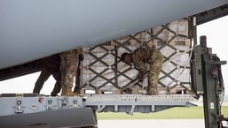 Pallets of Nestle Health Science Alfamino Infant and Alfamino Junior formula are unloaded from a US military aircraft at Indianapolis International Airport in Indianapolis, Indiana.