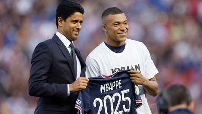 Paris St Germain's Kylian Mbappe poses for a photo with Paris St Germain president Nasser Al-Khelaifi after signing a new contract (REUTERS)