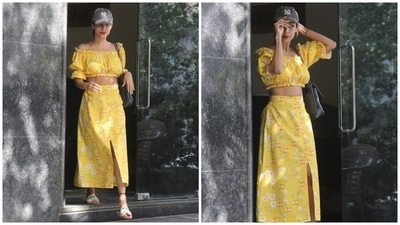Malaika's midi skirt features a high-rise waistline, an A-line shape skimming her curves aesthetically, a thigh-high slit on the front, and button-up details to cinch it together. In the end, Malaika rounded it all off with a messy bun, pink lip shade and a bare face. (HT Photo/Varinder Chawla) Malaika's midi skirt features a high-rise waistline, an A-line shape skimming her curves aesthetically, a thigh-high slit on the front, and button-up details to cinch it together. In the end, Malaika rounded it all off with a messy bun, pink lip shade and a bare face. (HT Photo/Varinder Chawla)