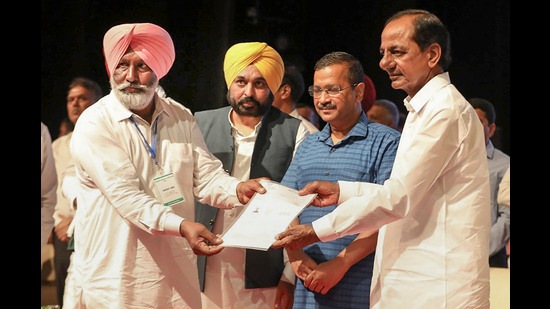 Telangana CM KCR, Delhi CM Arvind Kejriwal and Punjab CM Bhagwant Mann during a function to provide financial assistance to the kin of the farmers, who died during the protest over farm reform laws, in Chandigarh, Sunday. (PTI)