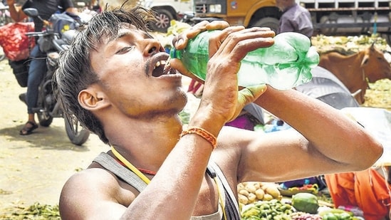 New Delhi: A man drinks water to quench his thirst on a hot summer day, in New Delhi, Tuesday, May 17, 2022. (PTI Photo/Shahbaz Khan)(PTI05_17_2022_000187B) (PTI)