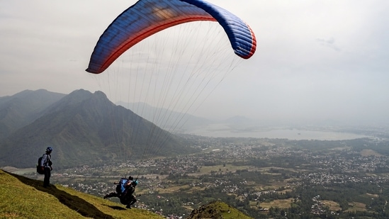 A tourist enjoys paragliding over the city in Srinagar on Sunday. &nbsp;(Imran Nissar/ANI Photo)