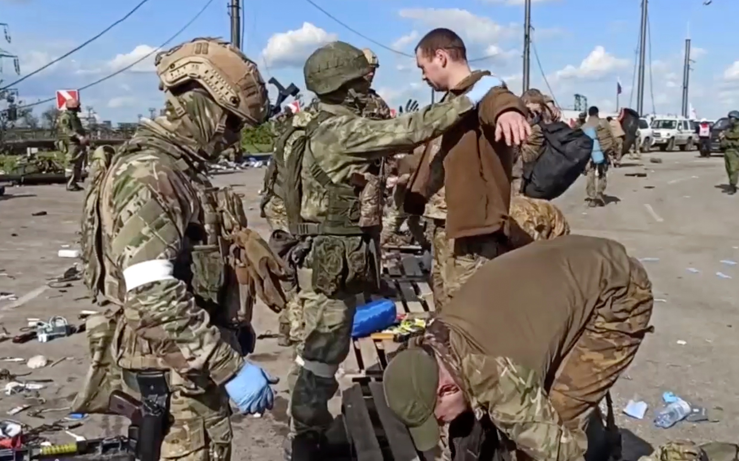 In this photo taken from video released by the Russian defence ministry on May 20, 2022, Russian servicemen frisk Ukrainian servicemen after they leaved the besieged Azovstal steel plant in Mariupol. (Via AP) In this photo taken from video released by the Russian defence ministry on May 20, 2022, Russian servicemen frisk Ukrainian servicemen after they leaved the besieged Azovstal steel plant in Mariupol. (Via AP)
