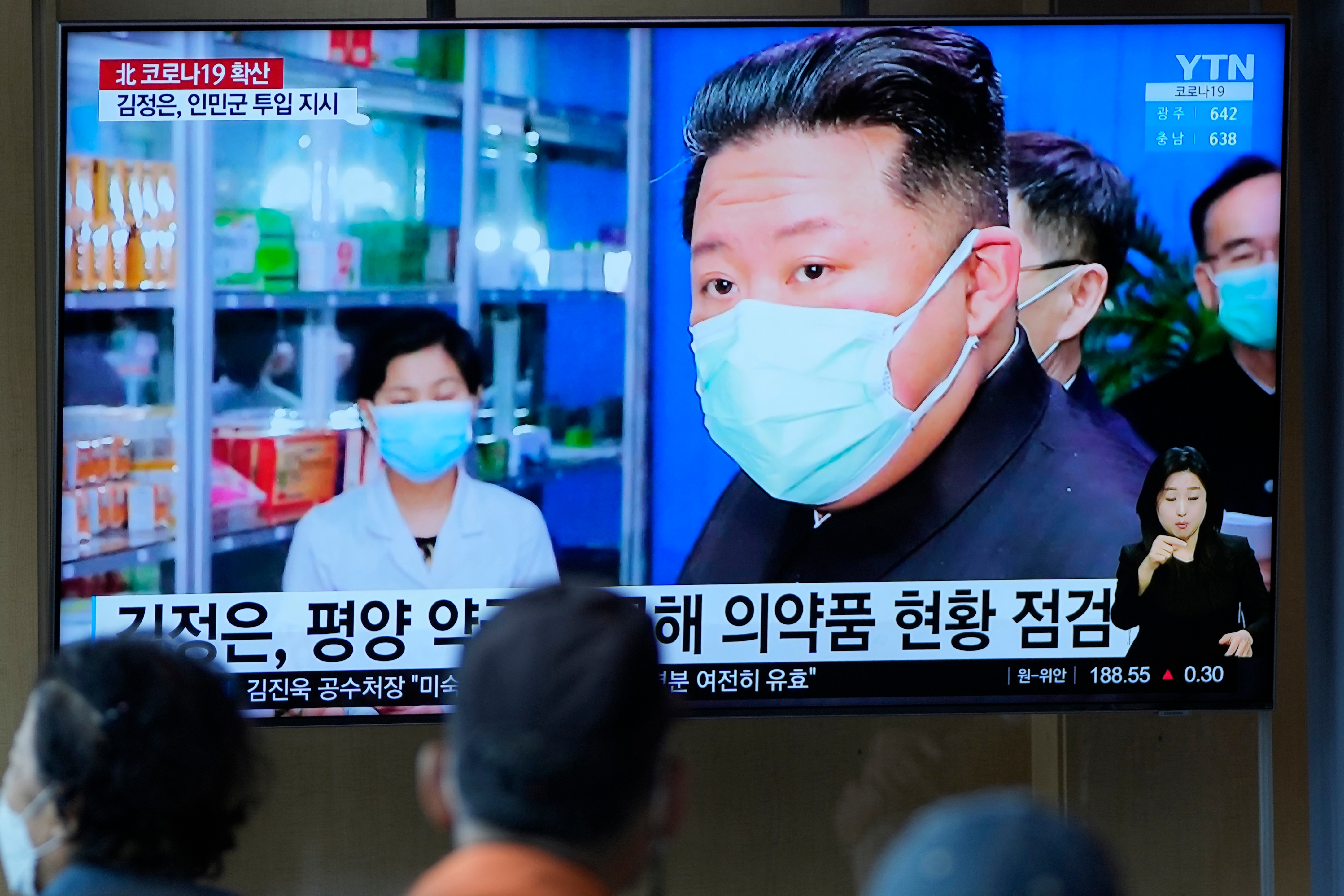 FILE - People watch a TV screen showing a news program reporting with an image of North Korean leader Kim Jong Un, at a train station in Seoul, South Korea on May 16, 2022. North Korean propaganda describes an all-out effort to fight a suspected COVID-19 outbreak that has sickened nearly 2 million people. But defectors say fear is palpable among North Korean citizens who lack access to hospital care and struggle to afford even basic medicine. (AP) FILE - People watch a TV screen showing a news program reporting with an image of North Korean leader Kim Jong Un, at a train station in Seoul, South Korea on May 16, 2022. North Korean propaganda describes an all-out effort to fight a suspected COVID-19 outbreak that has sickened nearly 2 million people. But defectors say fear is palpable among North Korean citizens who lack access to hospital care and struggle to afford even basic medicine. (AP)