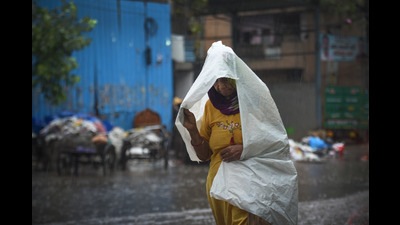 A commuter out in the rain, Shadipur, New Delhi, India, May 23, 2022 (Sanchit Khanna/Hindustan Times) A commuter out in the rain, Shadipur, New Delhi, India, May 23, 2022 (Sanchit Khanna/Hindustan Times)