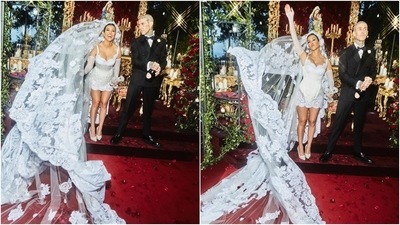 Kourtney chose a white silk lace and satin mini wedding dress and a larger-than-life hand-embroidered veil for the special day. According to Dolce & Gabbana's Instagram, the designers took inspiration from the 'iconic figures of the Italian lingerie' to design Kourtney's sleeveless dress. It comes with a silhouette-enhancing corset, plunging neckline, and scalloped hems. (Instagram/@kourtneykardashian) Kourtney chose a white silk lace and satin mini wedding dress and a larger-than-life hand-embroidered veil for the special day. According to Dolce & Gabbana's Instagram, the designers took inspiration from the 'iconic figures of the Italian lingerie' to design Kourtney's sleeveless dress. It comes with a silhouette-enhancing corset, plunging neckline, and scalloped hems. (Instagram/@kourtneykardashian)