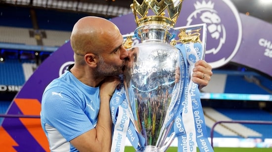 Manchester City manager Pep Guardiola kisses the Premier League trophy after his side won the English Premier League(AP)