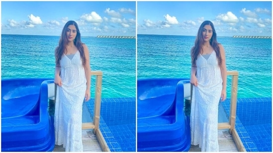 Disha posted the photos of herself dressed in the white georgette maxi dress with the caption, "Sea Angel." Her ensemble is from the shelves of the luxe boho clothing label Loca Bonita. She teamed it with minimal accessories, including hoop earrings embellished with emerald stones, white acrylic nail paint and white slip-on sandals.(Instagram)