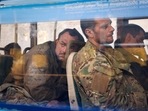 Ukrainian servicemen sit in a bus after they were evacuated from the besieged Mariupol's Azovstal steel plant.&nbsp;