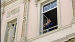 A flautist performs at his window for his neighbours in Brussels, Belgium, during the lockdown in 2020. This sort of communal form of art making like the “balcony and courtyard concerts” in his story, The Mask, appeals to Carlo Pizzati. (Shutterstock) A flautist performs at his window for his neighbours in Brussels, Belgium, during the lockdown in 2020. This sort of communal form of art making like the “balcony and courtyard concerts” in his story, The Mask, appeals to Carlo Pizzati. (Shutterstock)