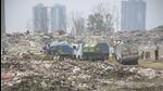 On Tuesday, dozens of vehicles of the Ghaziabad municipal corporation which were laden with solid waste were seen lined up outside the landfill site. The local residents said that there has been an attempt to dump fresh solid waste at the site and rains will further aggravate the matter. (Sakib Ali/HT Photo)