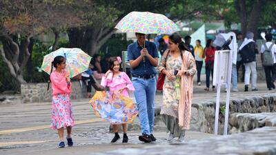 Visitors enjoying the rainy weather at Sukhna Lake in Chandigarh on Tuesday. (Ravi Kumar/HT) Visitors enjoying the rainy weather at Sukhna Lake in Chandigarh on Tuesday. (Ravi Kumar/HT)