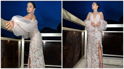 Helly wore a pale pink gown and posed on her Cannes hotel room balcony for this third photoshoot. The dress is from designer Dany Atrache's label. It features a square neckline with a front cut-out going up to Helly's waist and a pleated tulle overlay on the torso extending up to form off-the-shoulder billowy statement sleeves. (Instagram) Helly wore a pale pink gown and posed on her Cannes hotel room balcony for this third photoshoot. The dress is from designer Dany Atrache's label. It features a square neckline with a front cut-out going up to Helly's waist and a pleated tulle overlay on the torso extending up to form off-the-shoulder billowy statement sleeves. (Instagram)