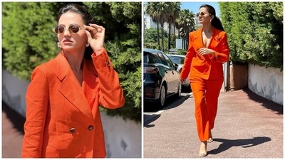 The last look shows Helly exploring Cannes dressed in an orange shirtless monotone pantsuit. The actor wore a double-breasted blazer - featuring notch lapels, long sleeves and a loose silhouette - with a matching pair of pants, sunglasses, heels, pearl earrings, soft-glow makeup and a sleek hairdo. (Instagram) The last look shows Helly exploring Cannes dressed in an orange shirtless monotone pantsuit. The actor wore a double-breasted blazer - featuring notch lapels, long sleeves and a loose silhouette - with a matching pair of pants, sunglasses, heels, pearl earrings, soft-glow makeup and a sleek hairdo. (Instagram)