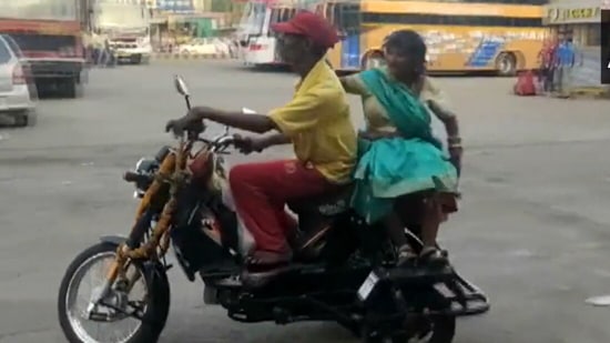 Santosh Kumar Sahu and his wife Munni on their new vehicle.(ANI)