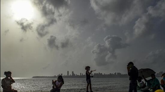 Mumbai: Youngsters sit at Marine Drive as dark monsoon clouds hover in the sky in Mumbai, Tuesday, May 24, 2022. (PTI Photo/Kunal Patil)(PTI05_24_2022_000165A) (PTI) Mumbai: Youngsters sit at Marine Drive as dark monsoon clouds hover in the sky in Mumbai, Tuesday, May 24, 2022. (PTI Photo/Kunal Patil)(PTI05_24_2022_000165A) (PTI)