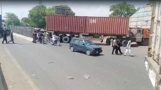 Shipping containers used to block roads in Islamabad's Red Zone ahead of Imran Khan and his PTI's planned rally, Tuesday, May 24, 2022.&nbsp;