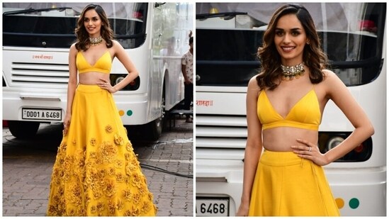 Manushi teamed the blouse with a matching yellow coloured lehenga decorated with tulle applique work in floral patterns, a high-rise waistline, heavy ghera and ribbon tie on the side to cinch the skirt together.(HT Photo/Varinder Chawla)
