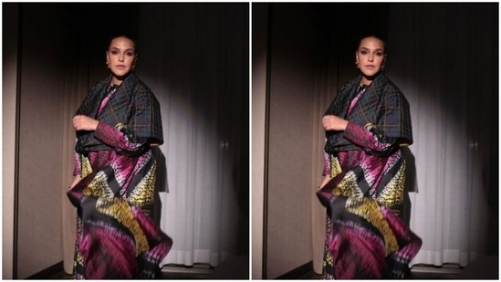 Neha’s silk kaftan came intricately printed in yellow, pink, white and black colours. Neha paired it with a grey shirt-styled cropped shrug.(Instagram/@nehadhupia)