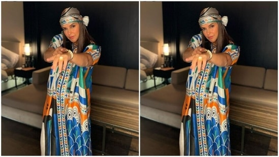 Neha’s half-sleeved kurta came in quirky prints of yellow, blue, white and black. She paired it with a pair of white trousers with wide legs.(Instagram/@nehadhupia)