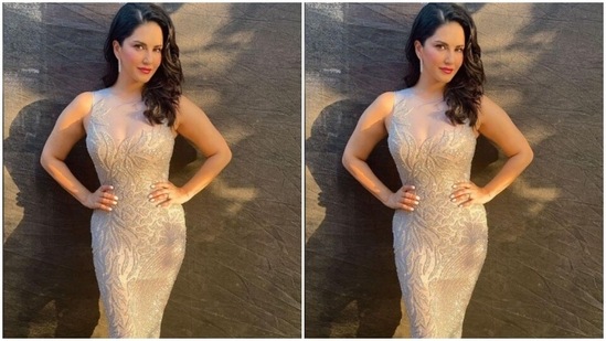 Sunny's white sleeveless gown came intricately decorated in silver embellishments. The body-hugging gown showed off her curves.(Instagram/@sunnyleone)