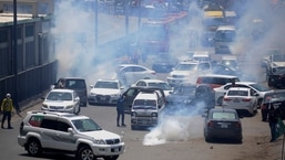 Police fire teargas to disperse supporters of Pakistan's key opposition party marching toward Islamabad, in Lahore, Pakistan, on Wednesday,&nbsp;