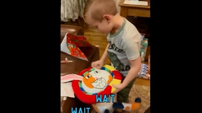 The image, taken from the Reddit video, shows the kid looking at the stuffed toy that his parents gifted him and is based on one of his drawings. (Reddit/@UchihaLegolas)