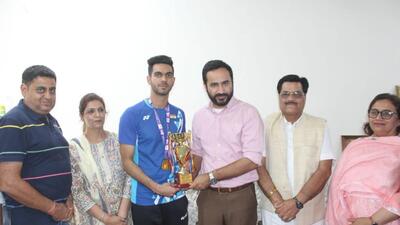State sports minister Gurmeet Singh Meet Hayer presenting a trophy to badminton player Dhruv Kapila in Ludhiana. (HT Photo)