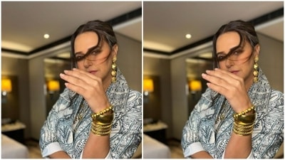 Neha teamed a white long dress intricately detailed in black and gold prints with a blazer of the same print. (Instagram/@nehadhupia)